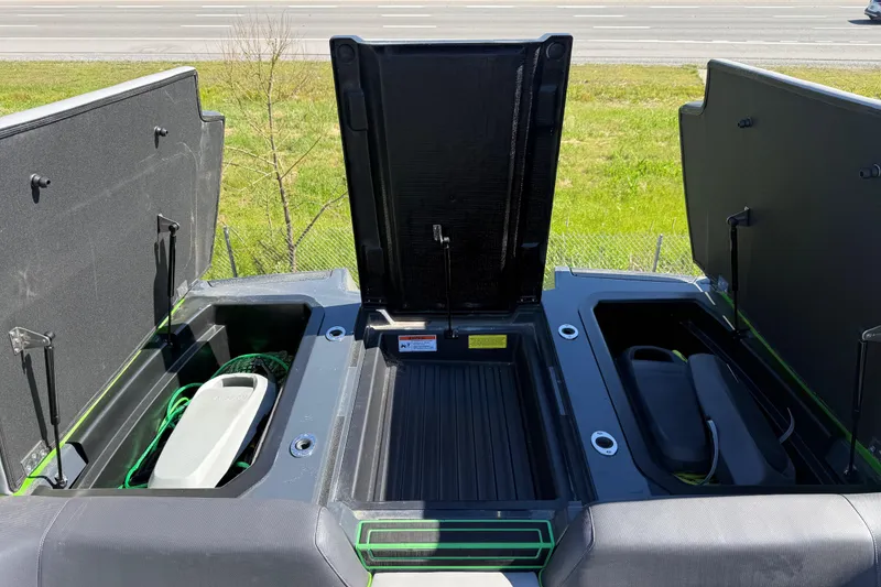Slide: The Image of 2022 Moomba Makai boat storage compartments open, showcasing interior space and equipment. - 15