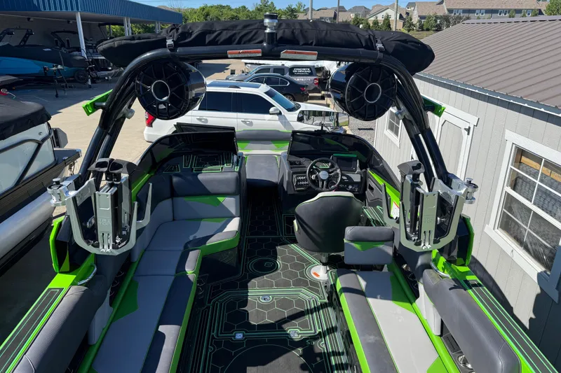 Slide: The Image of 2022 Moomba Makai boat interior with green accents and advanced sound system. - 19
