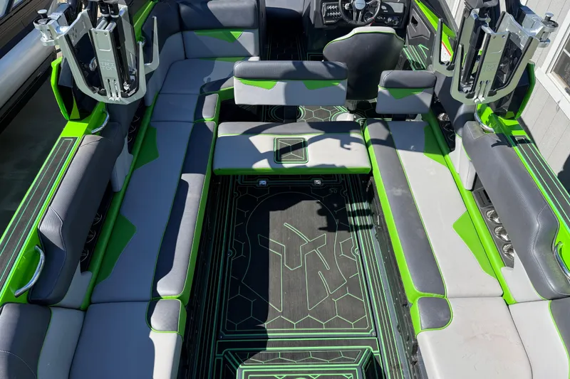 Slide: The Image of 2022 Moomba Makai boat interior with green and gray seating, modern design. - 21