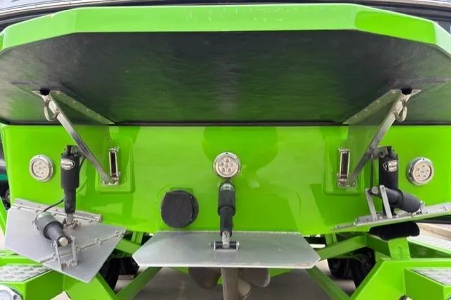 Slide: The Image of Rear view of a 2022 Moomba Makai boat with green hull and trim tabs. - 26