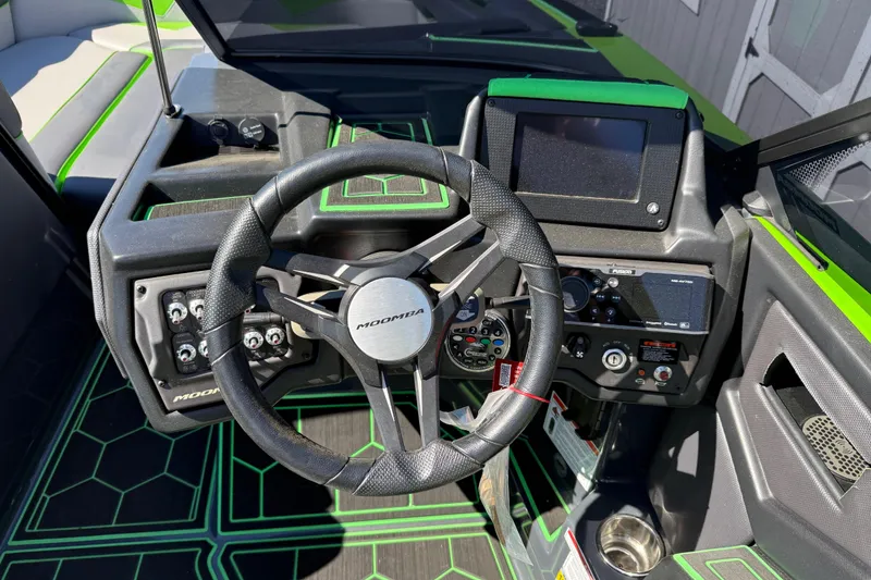 Slide: The Image of 2022 Moomba Makai boat dashboard with steering wheel and control panel. - 7