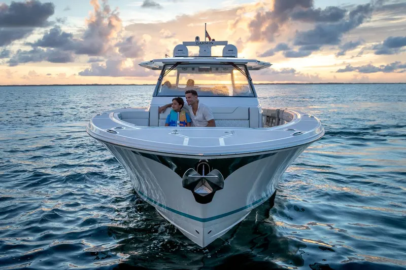 Slide: The Image of Manufacturer Provided Image: 2026 Regal 43 SAV boat cruising at sunset with passengers enjoying the view. - 2