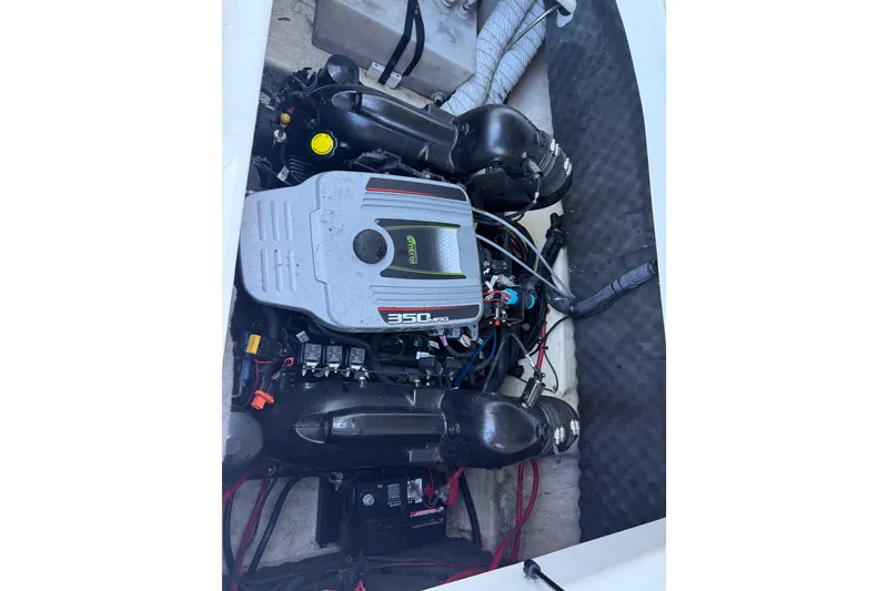 Slide: The Image of Engine compartment of a 2013 Rinker 246 Captiva Cuddy boat. - 12