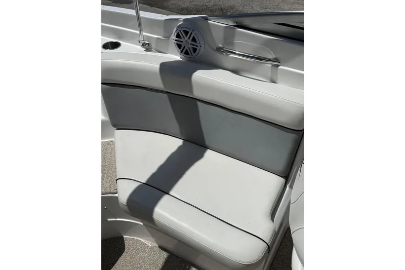 Slide: The Image of 2013 Rinker 246 Captiva Cuddy interior seating with speaker and handrail. - 17