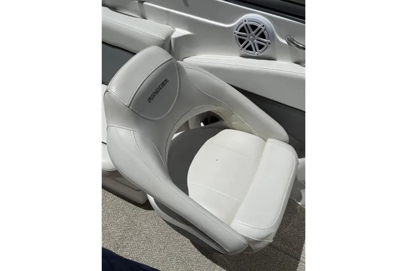 Slide: The Image of White leather seat on 2013 Rinker 246 Captiva Cuddy boat interior. - 19
