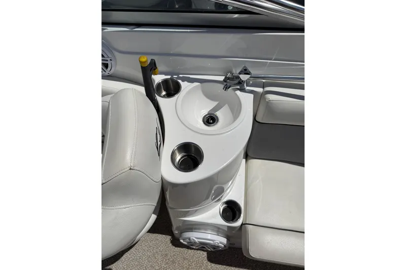 Slide: The Image of 2013 Rinker 246 Captiva Cuddy boat interior with sink and cup holders. - 20