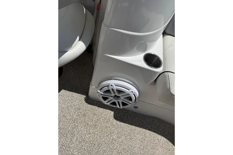Slide: The Image of 2013 Rinker 246 Captiva Cuddy interior with speaker and cup holder. - 21