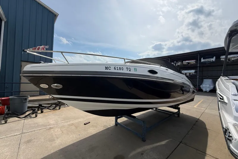 Slide: The Image of 2013 Rinker 246 Captiva Cuddy boat on display at a marina. - 7