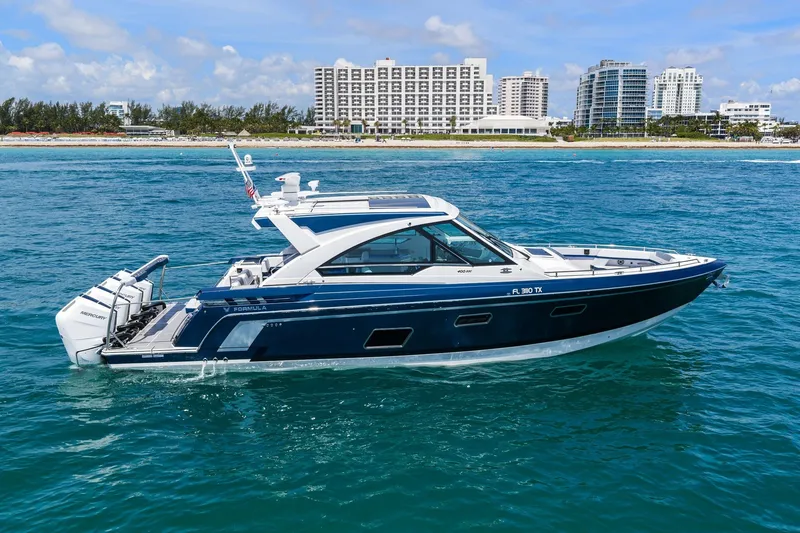 The Image of 2025 Formula 400 Super Sport Crossover yacht cruising near a coastal city skyline. - 0