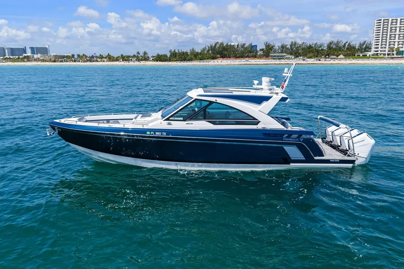 Slide: The Image of 2025 Formula 400 Super Sport Crossover boat on blue ocean near coastline. - 1