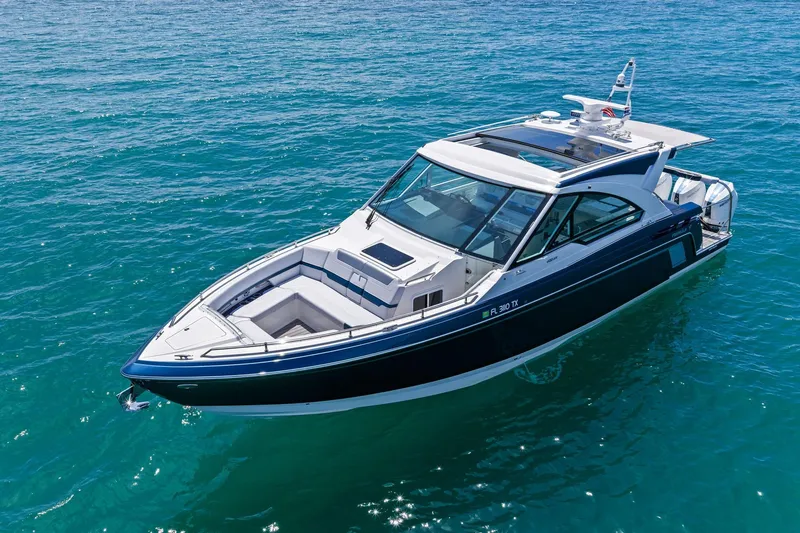 Slide: The Image of 2025 Formula 400 Super Sport Crossover boat on clear blue water. - 13