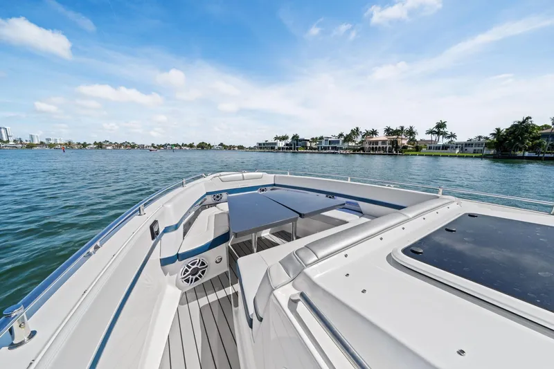Slide: The Image of 2025 Formula 400 Super Sport Crossover yacht on serene water with luxury seating. - 15