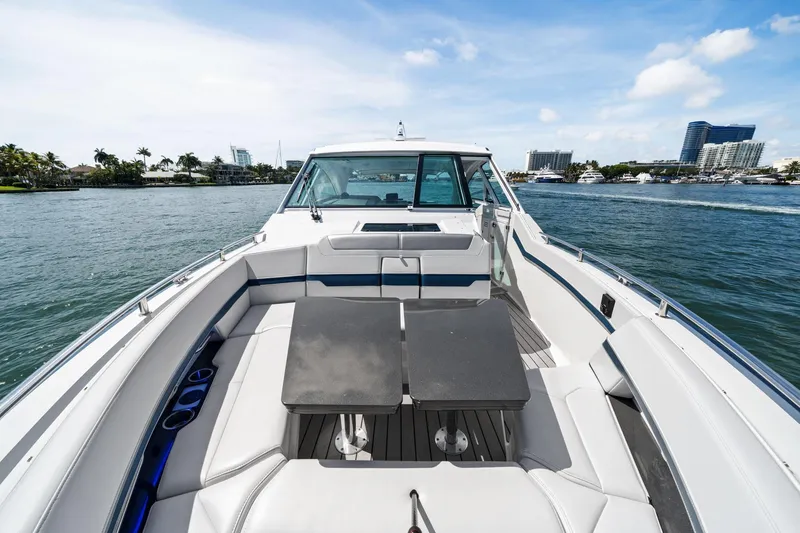 Slide: The Image of 2025 Formula 400 Super Sport Crossover yacht on water, featuring spacious seating and table. - 16