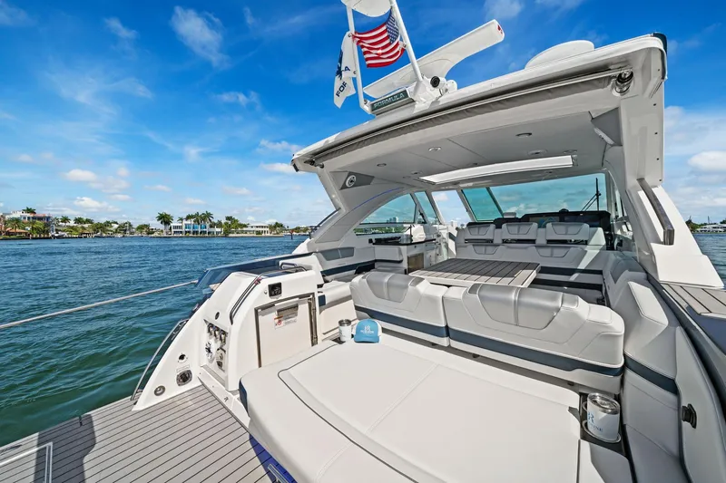 Slide: The Image of 2025 Formula 400 Super Sport Crossover yacht with luxurious seating and scenic waterfront view. - 17