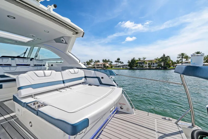 Slide: The Image of 2025 Formula 400 Super Sport Crossover yacht on serene water with luxurious seating. - 19