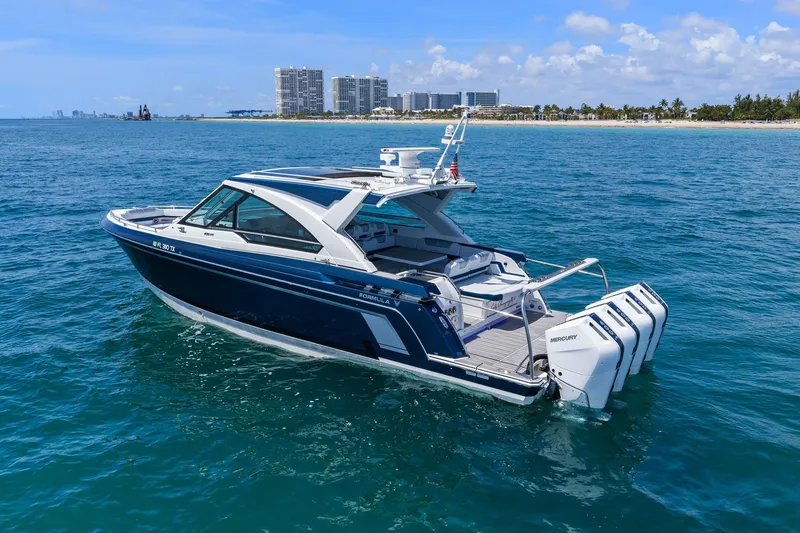 Slide: The Image of 2025 Formula 400 Super Sport Crossover boat on blue ocean near city skyline. - 3