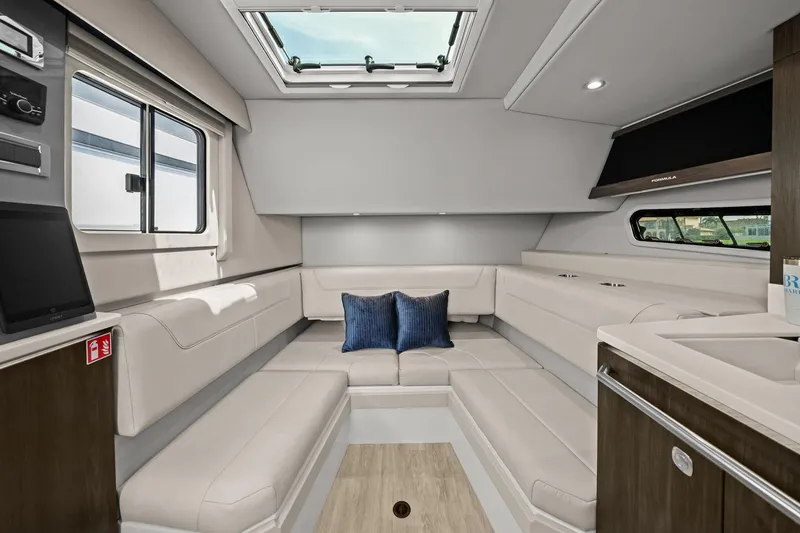 Slide: The Image of Luxurious interior of 2025 Formula 400 Super Sport Crossover yacht with plush seating and skylight. - 36