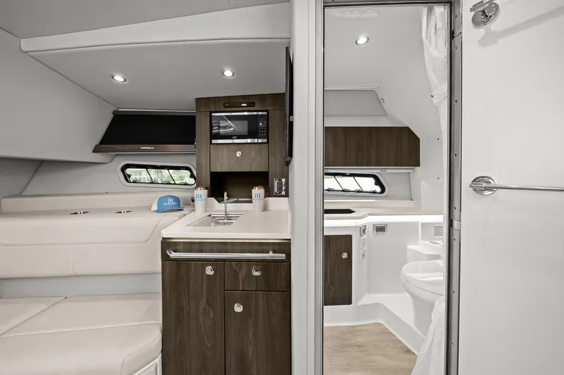 Slide: The Image of 2025 Formula 400 Super Sport Crossover interior with modern kitchenette and seating area. - 38