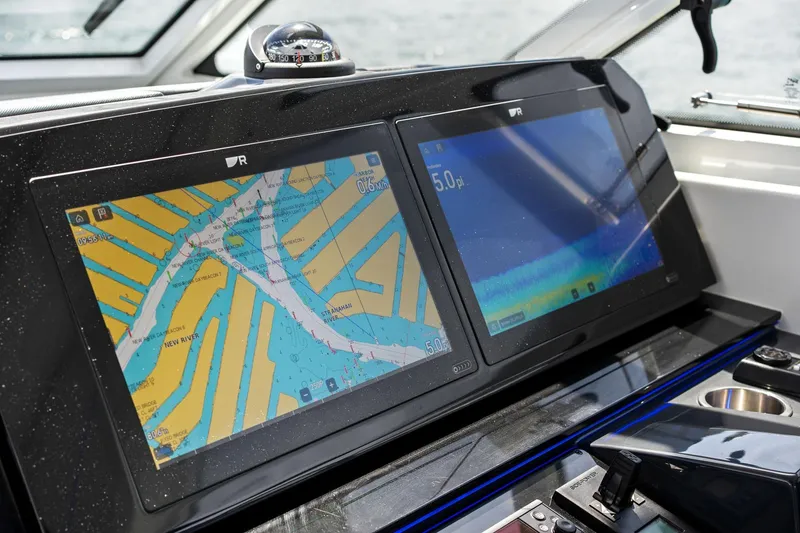 Slide: The Image of Dashboard of 2025 Formula 400 Super Sport Crossover with dual navigation screens. - 48