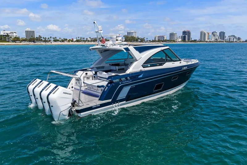 Slide: The Image of 2025 Formula 400 Super Sport Crossover yacht cruising near a city shoreline. - 6
