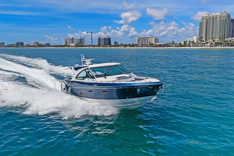 Slide: The Image of 2025 Formula 400 Super Sport Crossover cruising on clear blue ocean near city skyline. - 66