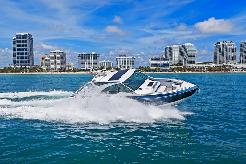 Slide: The Image of 2025 Formula 400 Super Sport Crossover cruising near city skyline on a sunny day. - 69