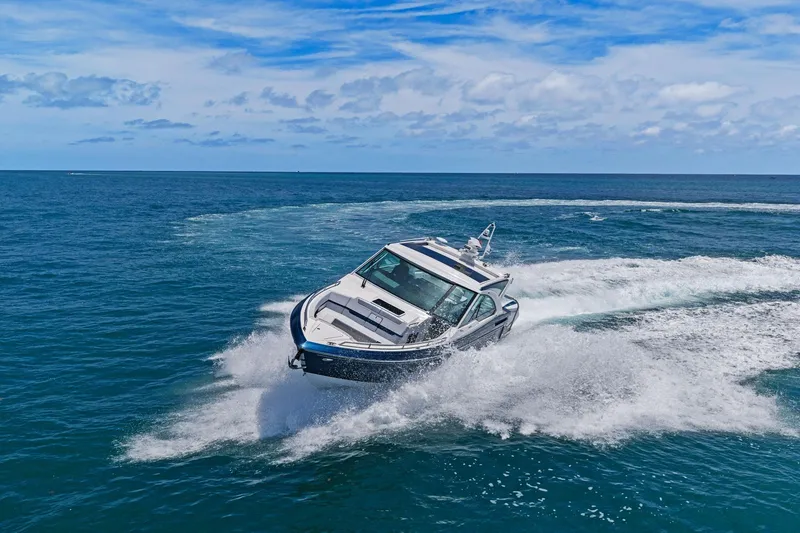 Slide: The Image of 2025 Formula 400 Super Sport Crossover cruising on open ocean under blue sky. - 71