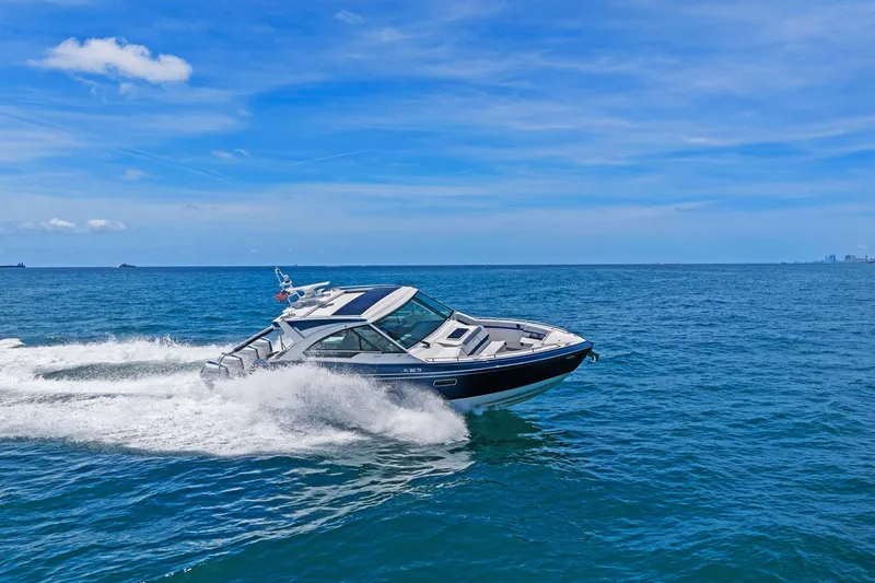 Slide: The Image of 2025 Formula 400 Super Sport Crossover cruising on open ocean under clear blue sky. - 74