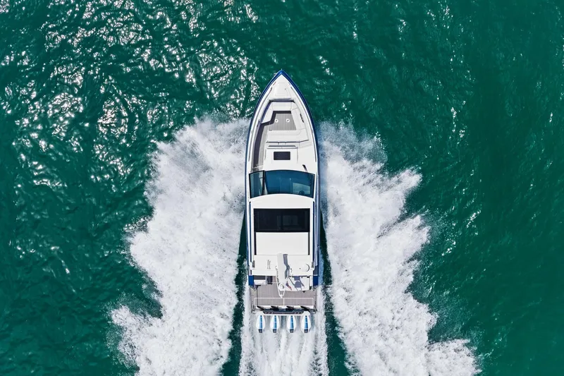 Slide: The Image of 2025 Formula 400 Super Sport Crossover cruising on turquoise water, aerial view. - 80