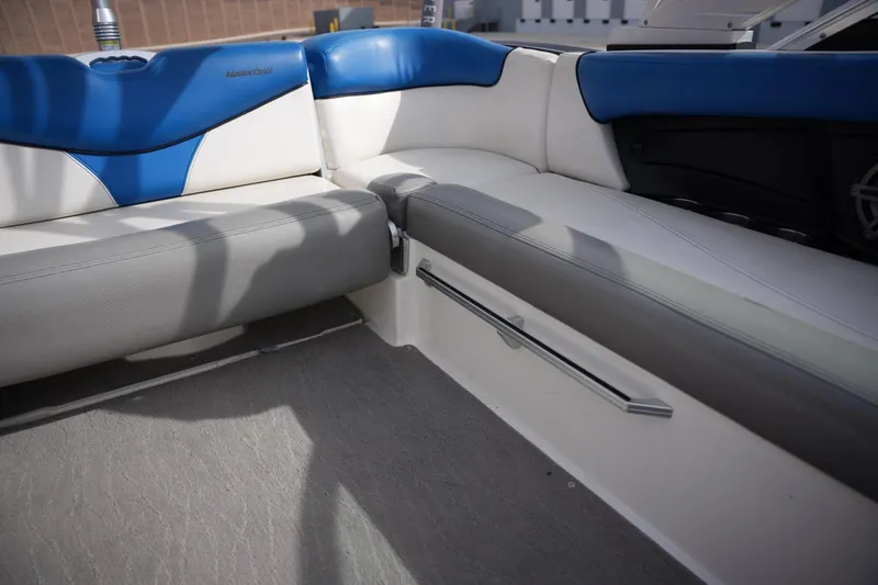 Slide: The Image of Interior seating of a 2016 MasterCraft X10 boat with blue and gray upholstery. - 14