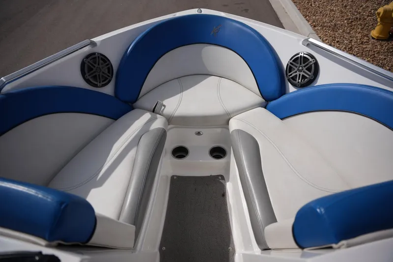 Slide: The Image of 2016 MasterCraft X10 boat interior with blue and white seating and speakers. - 9