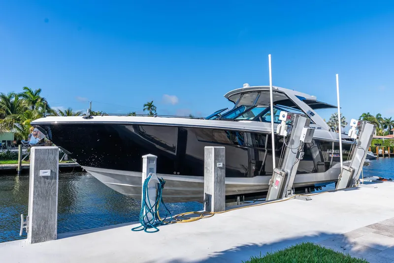 Slide: The Image of 2022 Monterey 378SS Super Sport boat docked by a canal under clear blue skies. - 12