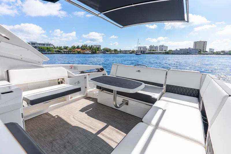 Slide: The Image of Luxurious seating area on a 2022 Monterey 378SS Super Sport boat, overlooking a scenic waterfront. - 16