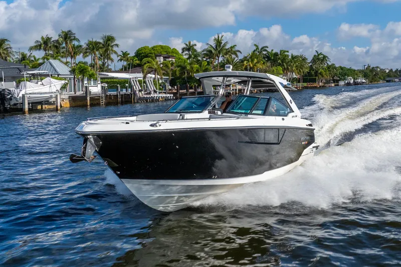 Slide: The Image of 2022 Monterey 378SS Super Sport cruising on a sunny waterway with palm trees. - 20