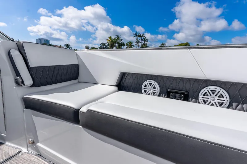Slide: The Image of Luxurious seating on 2022 Monterey 378SS Super Sport boat with speakers, under blue sky. - 21