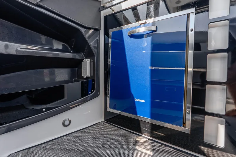 Slide: The Image of Interior view of a 2022 Monterey 378SS Super Sport boat featuring a blue Isotherm fridge. - 22
