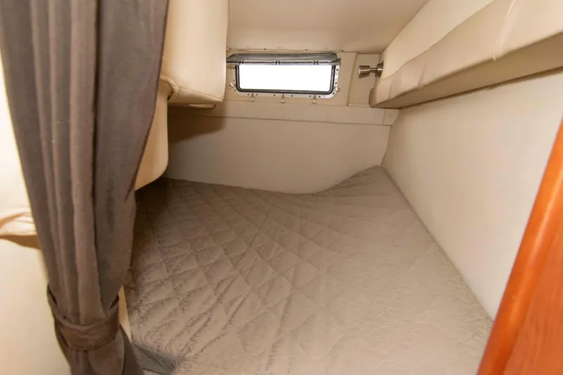Slide: The Image of Interior cabin of 2006 Larson Cabrio 240 boat with cozy sleeping area. - 11