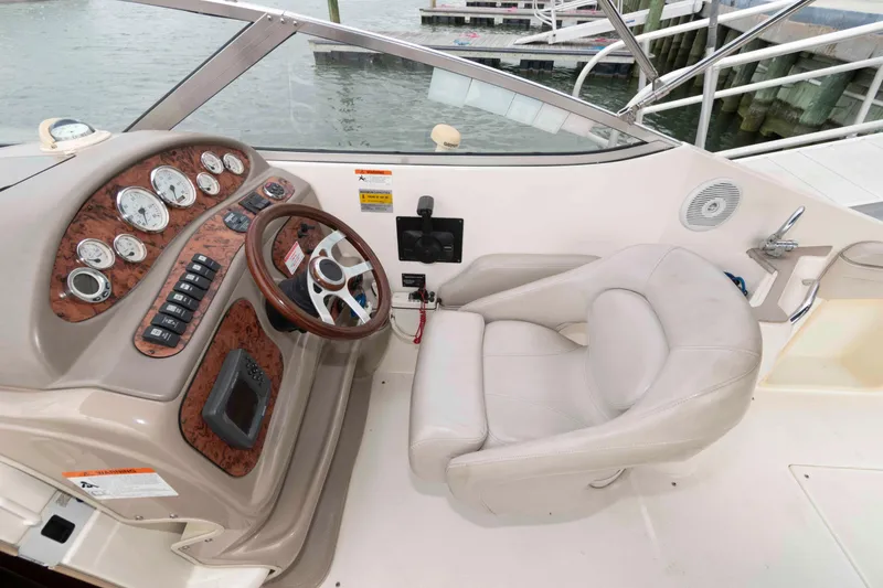 Slide: The Image of 2006 Larson Cabrio 240 boat cockpit with steering wheel and control panel. - 4