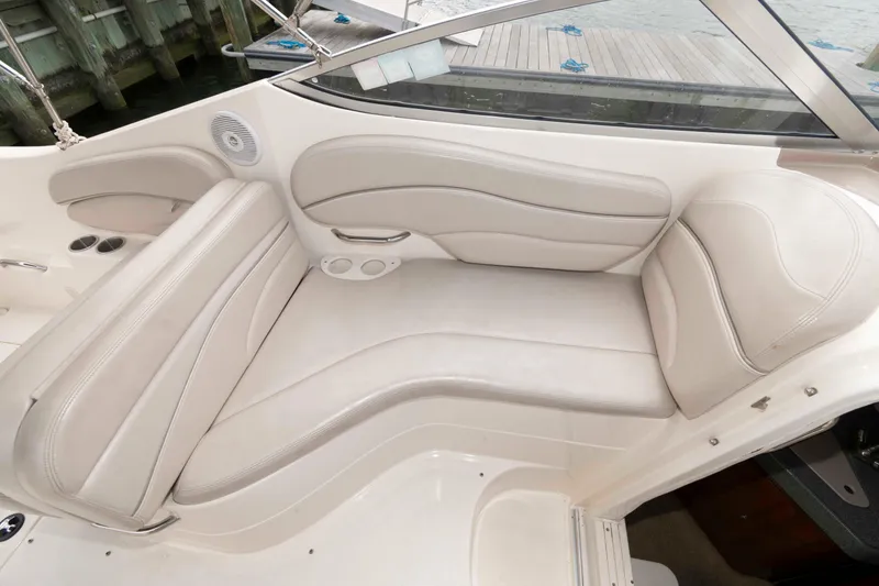 Slide: The Image of 2006 Larson Cabrio 240 boat interior with white leather seating and cup holders. - 6