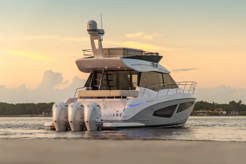 Slide: The Image of Manufacturer Provided Image: 2026 Regal 42 FXO yacht at sunset, featuring sleek design and powerful engines. - 2