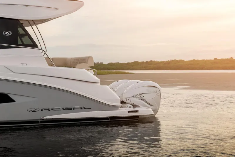 Slide: The Image of Manufacturer Provided Image: 2026 Regal 42 FXO yacht on serene water at sunset. - 3