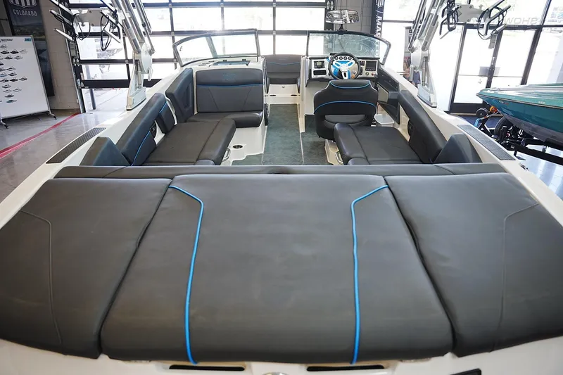 Slide: The Image of 2019 MasterCraft NXT22 boat interior with sleek black seating and modern dashboard. - 17