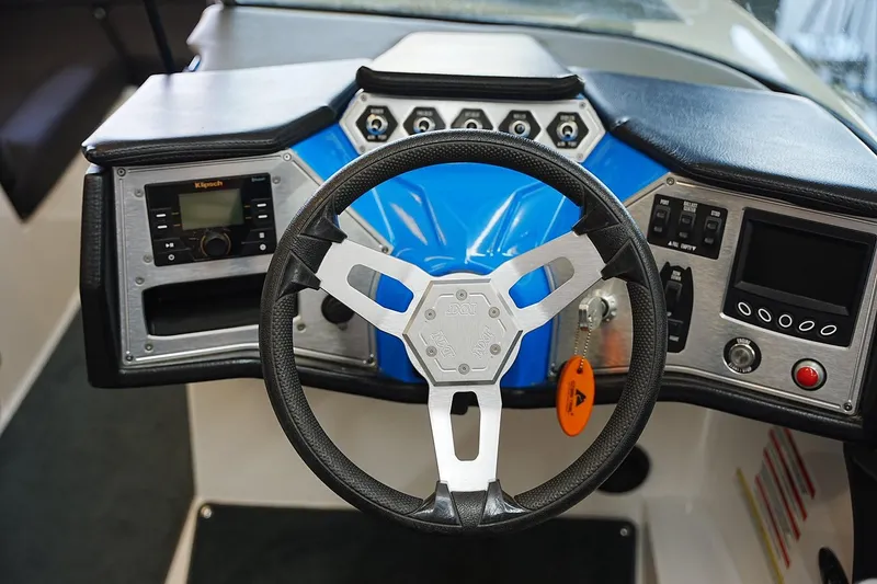 Slide: The Image of Steering wheel and dashboard of 2019 MasterCraft NXT22 boat, featuring modern controls. - 9