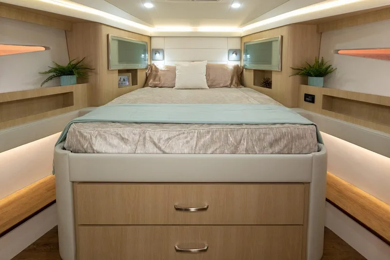 Slide: The Image of Manufacturer Provided Image: Luxurious cabin interior of 2026 Regal 42 XO yacht with modern decor and cozy bedding. - 12