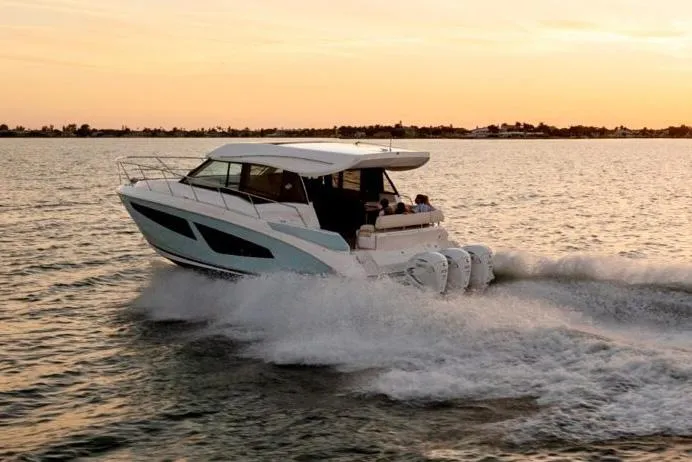 Slide: The Image of Manufacturer Provided Image: 2026 Regal 42 XO yacht cruising at sunset on open water. - 2