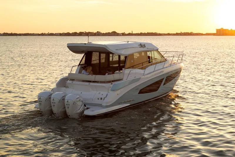 Slide: The Image of Manufacturer Provided Image: 2026 Regal 42 XO yacht cruising at sunset on calm waters. - 3