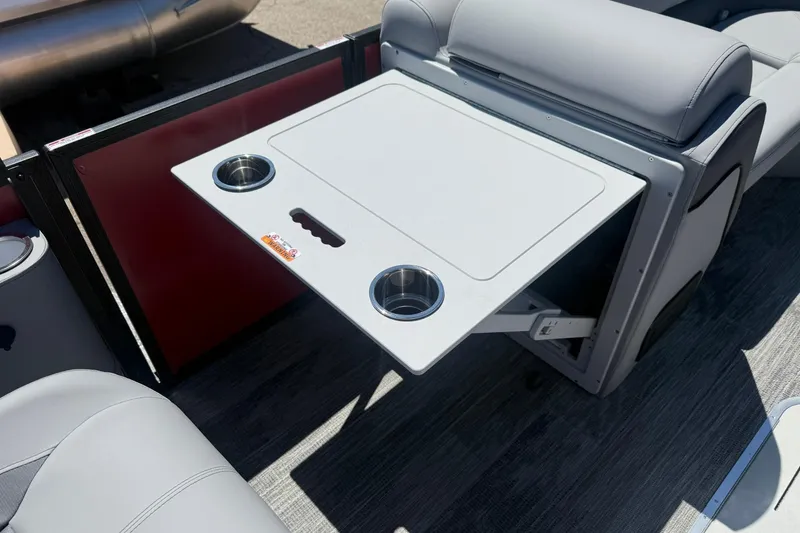 Slide: The Image of 2026 Bentley Pontoons Elite 223 Swingback interior with foldable table and cup holders. - 13