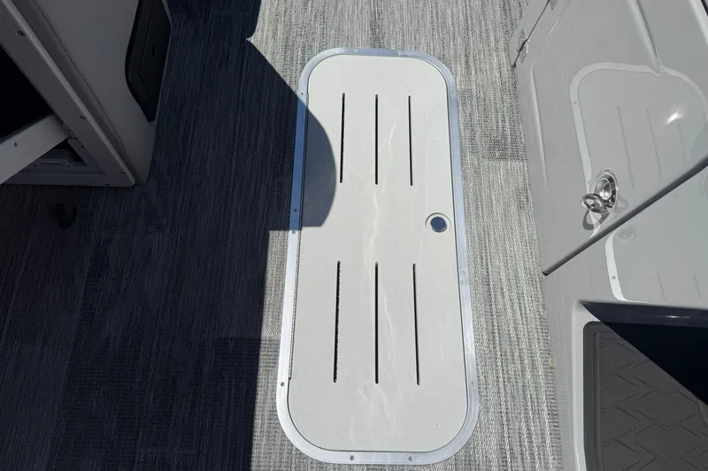 Slide: The Image of 2026 Bentley Pontoons Elite 223 Swingback deck with sleek flooring and storage hatch. - 14