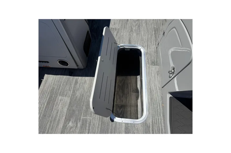 Slide: The Image of 2026 Bentley Pontoons Elite 223 Swingback storage compartment with open hatch on deck. - 15