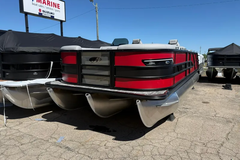 Slide: The Image of 2026 Bentley Pontoons Elite 223 Swingback, red and black design, displayed outdoors. - 2